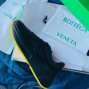 BNWT Bottega Veneta black sneakers with yellow soles.